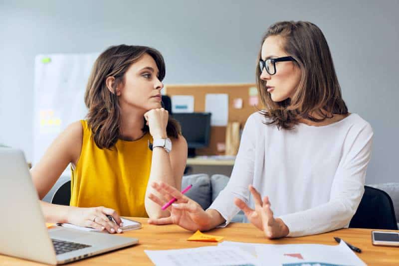 Zwei attraktive junge Kollegen sprechen über ihr Start-up-Unternehmen