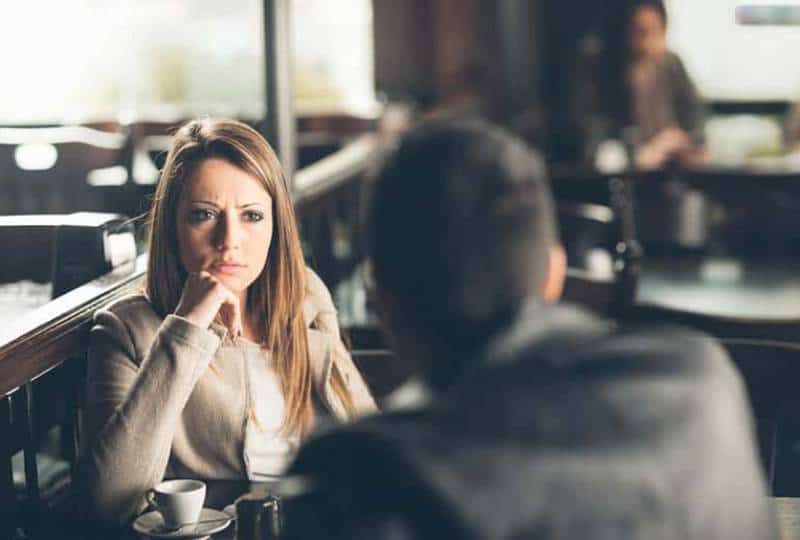 verärgerte Frau, die Mann im Café ansieht