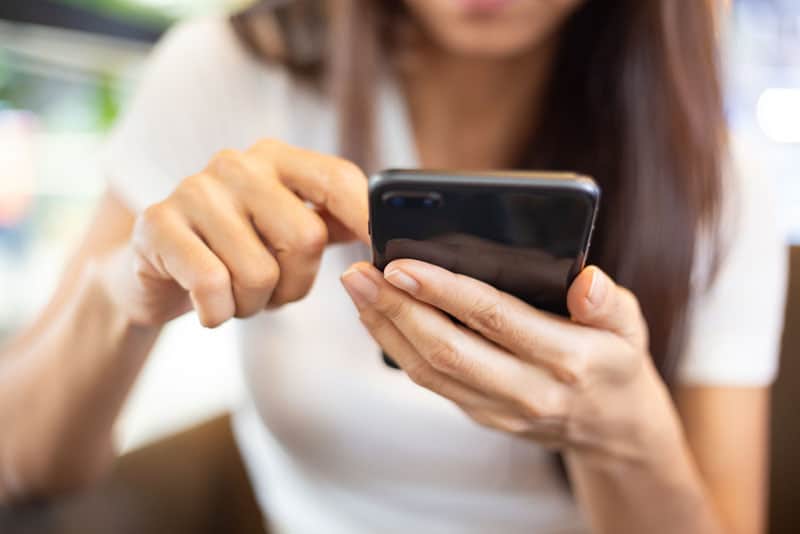 Frau hält Telefon