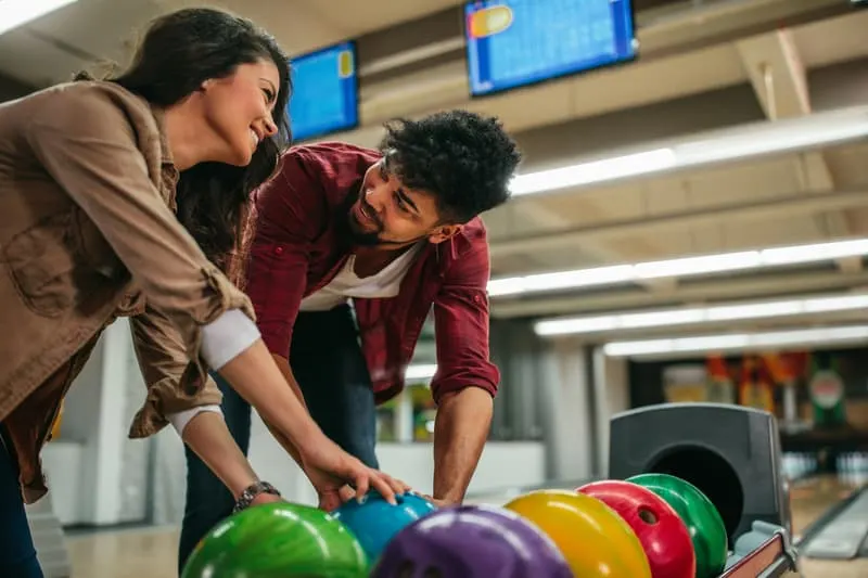  young couple choosing bowling balls 