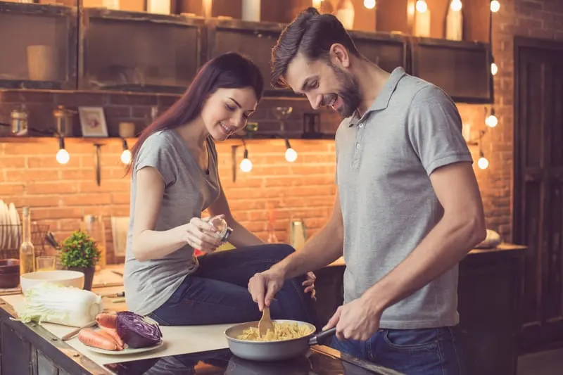 young couple cooking together in the kitchen