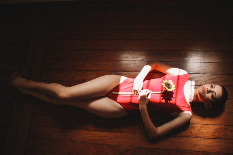 Ballerina mit Sonnenblume in den Händen liegen