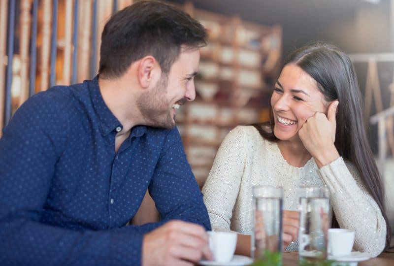 lächelndes Paar, das im Kaffee im Café genießt