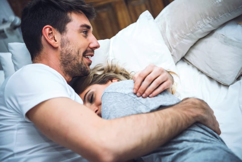schönes Paar im Bett umarmen