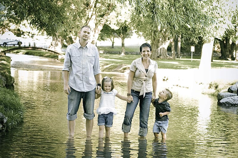 Eltern und ihre Kinder stehen im Fluss