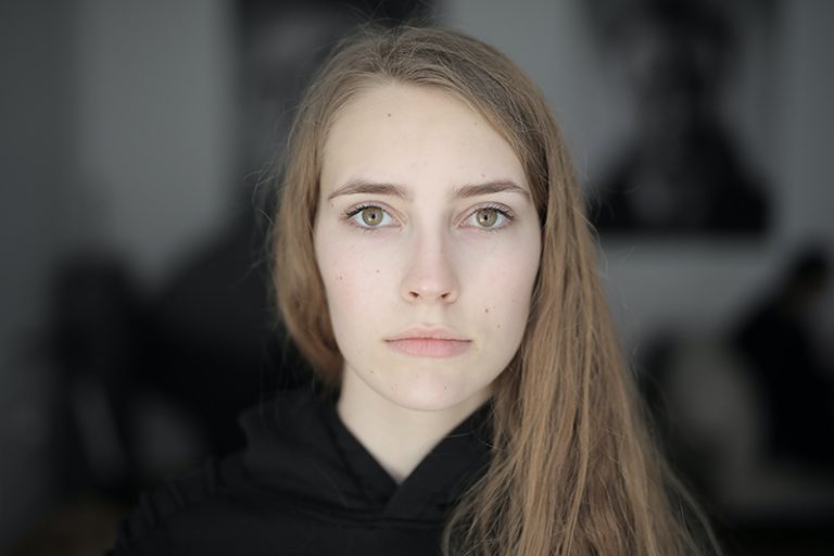 eine ernsthafte Frau, die einen schwarzen Hoodie trägt