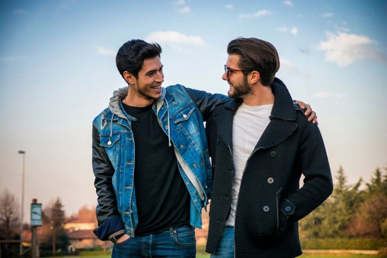 zwei beste Freunde gehen in Umarmung und reden