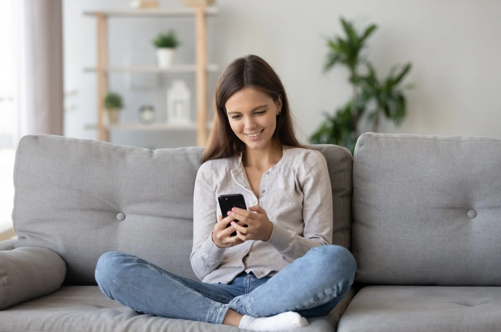 frau auf dem sofa mit handy