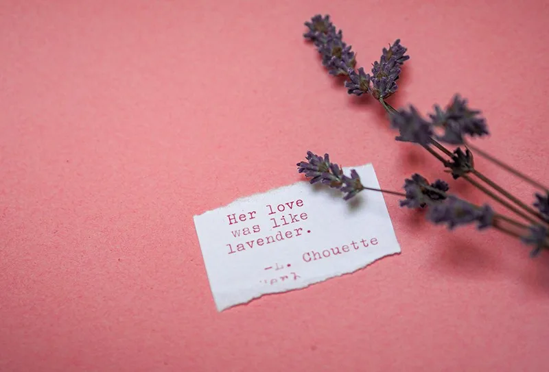 ein romantisches Zitat auf einer Notiz mit Lavendel daneben