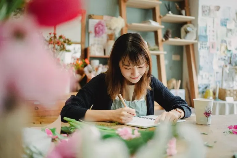 smiling woman writing letter
