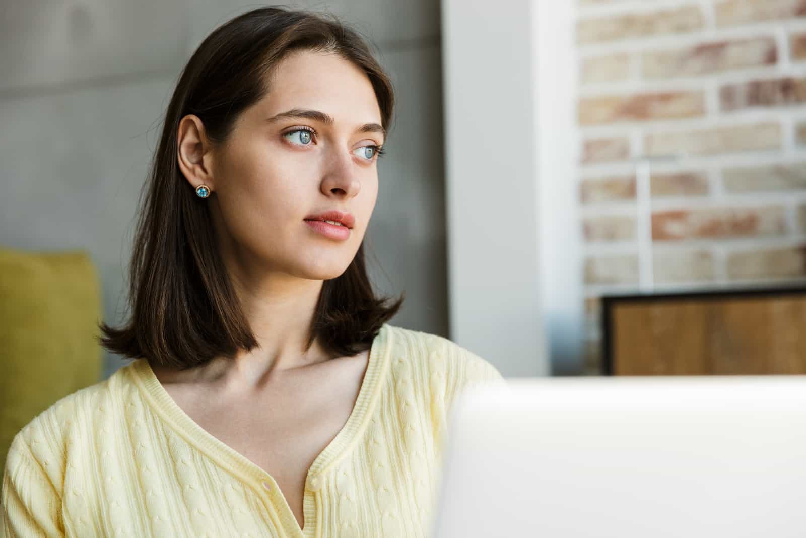 Brünette Frau mit Laptop-Computer beim Sitzen
