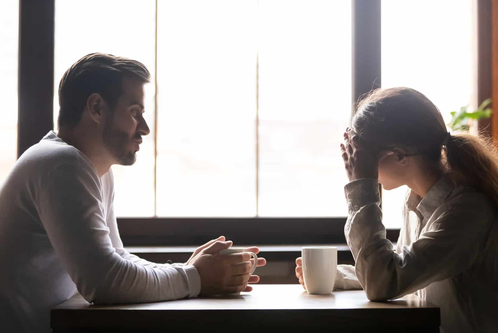 Frau und Mann sprechen im Café über Probleme in Beziehungen