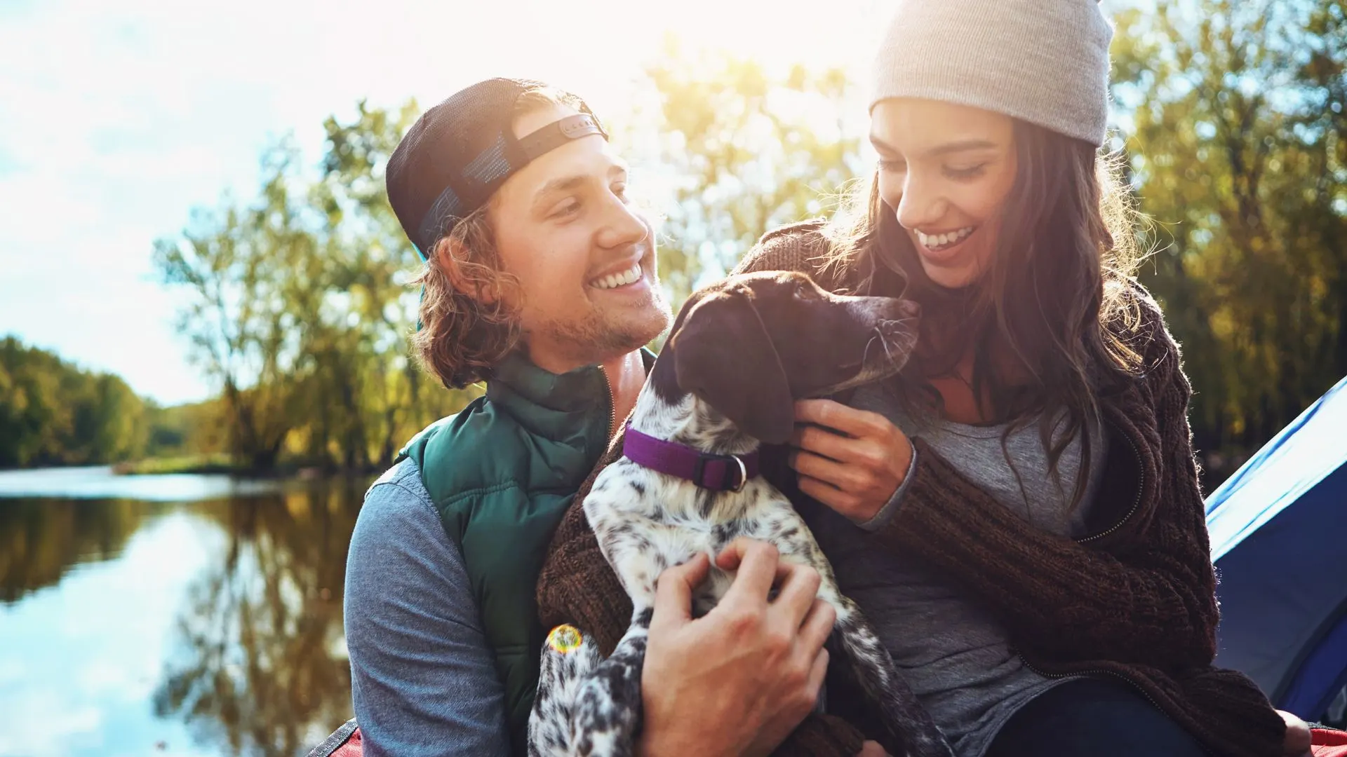 laechelndes Liebespaar mit einem Hund