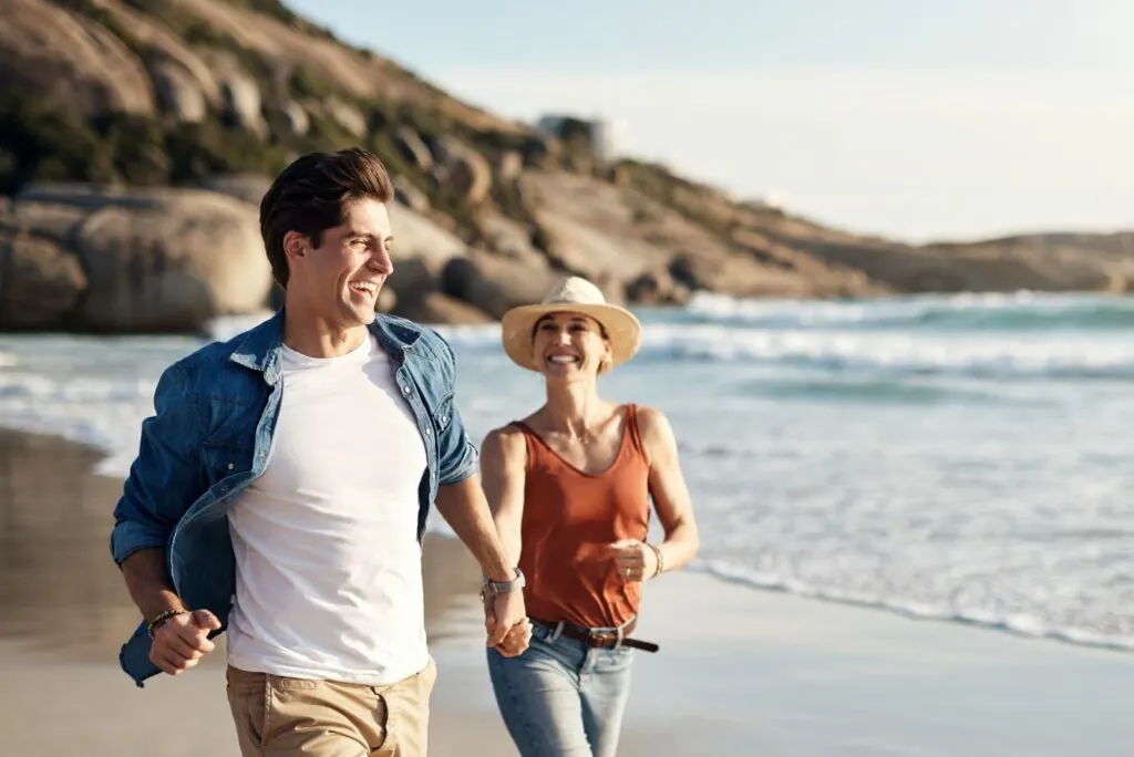 Ein Liebespaar läuft am Strand entlang