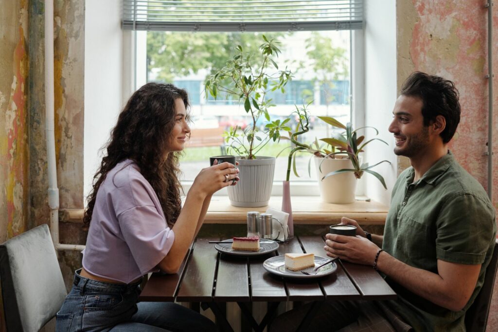 Ein Mann und eine Frau sitzen in einem Café und unterhalten sich