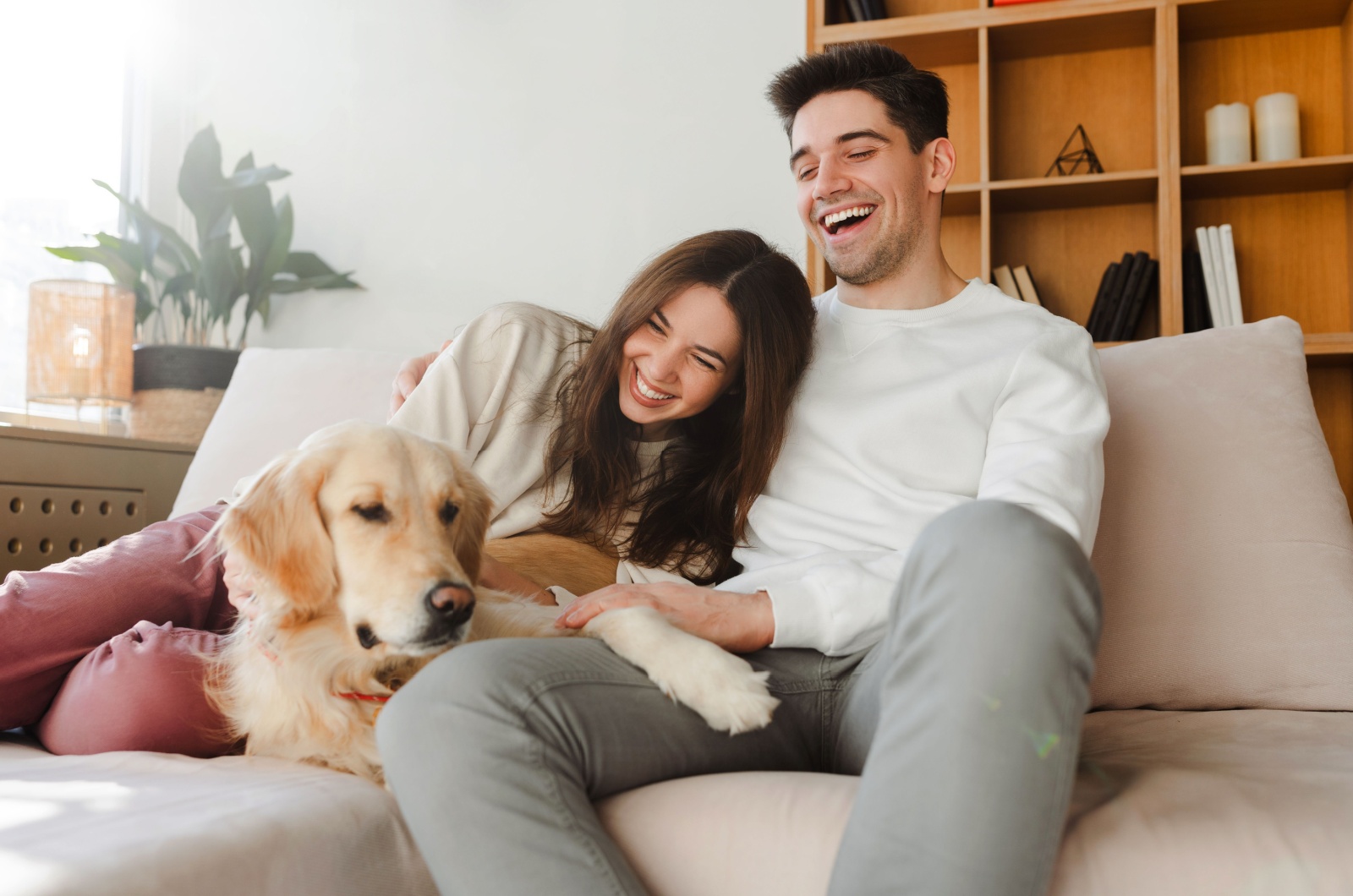 Paar lacht und sitzt auf einer Couch