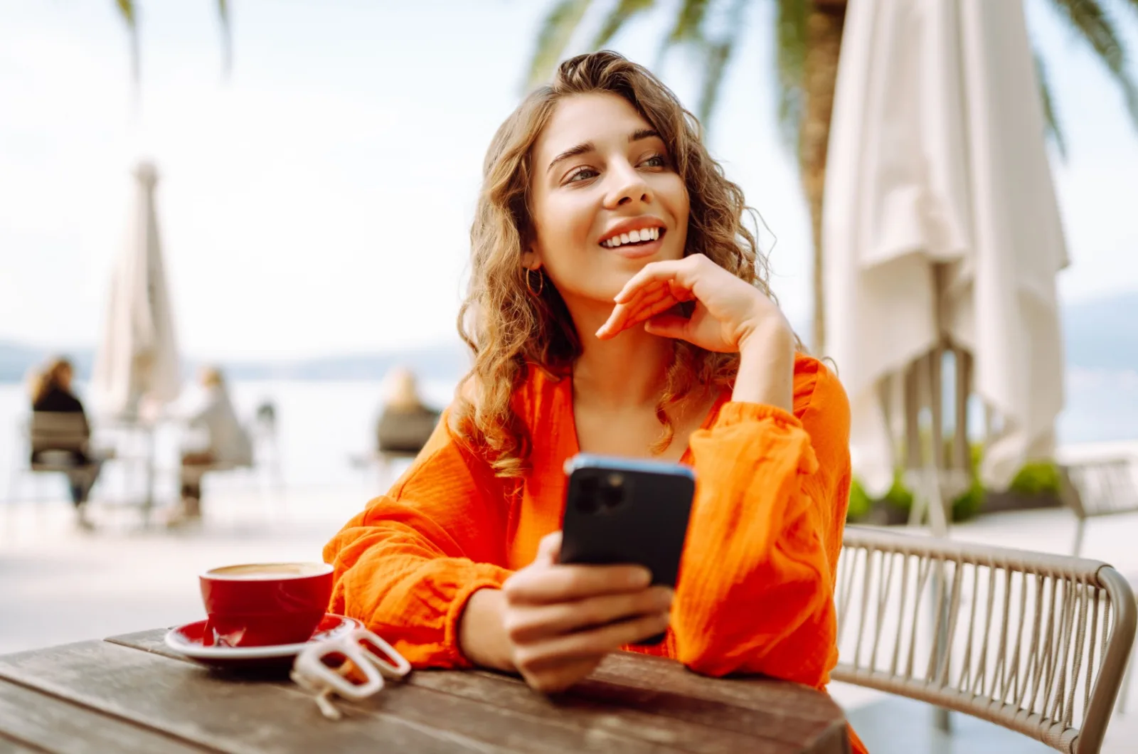 Frau im Café mit ihrem Telefon