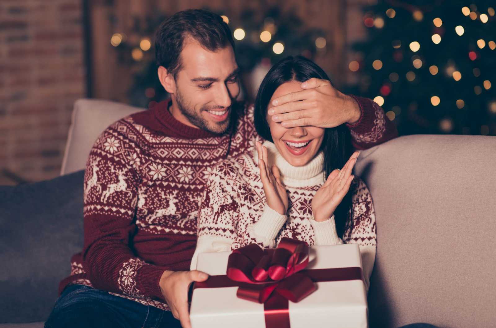 Mann haelt ein Geschenk fuer Frau