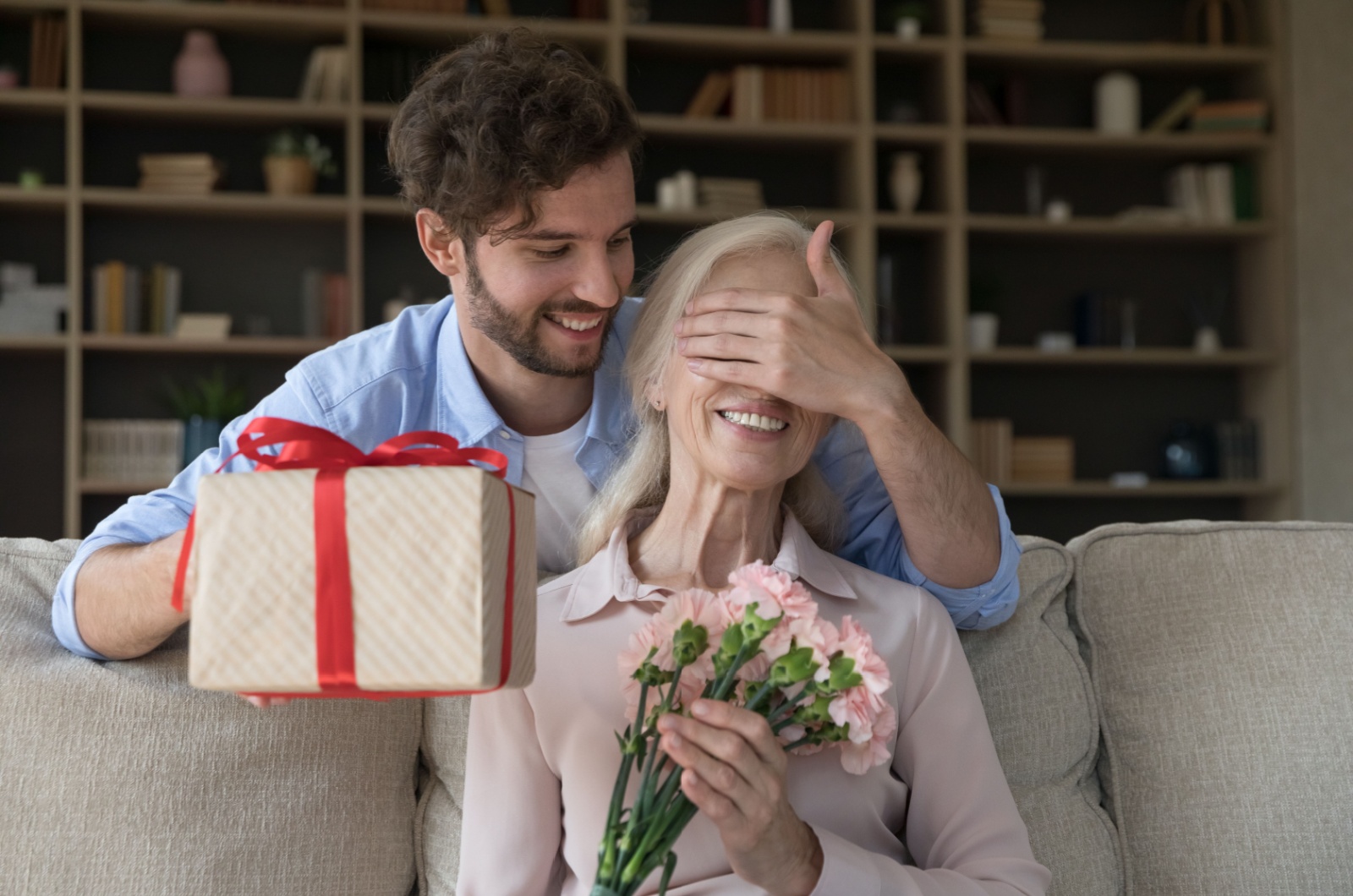 frau mittleren alters die ein geschenk haelt
